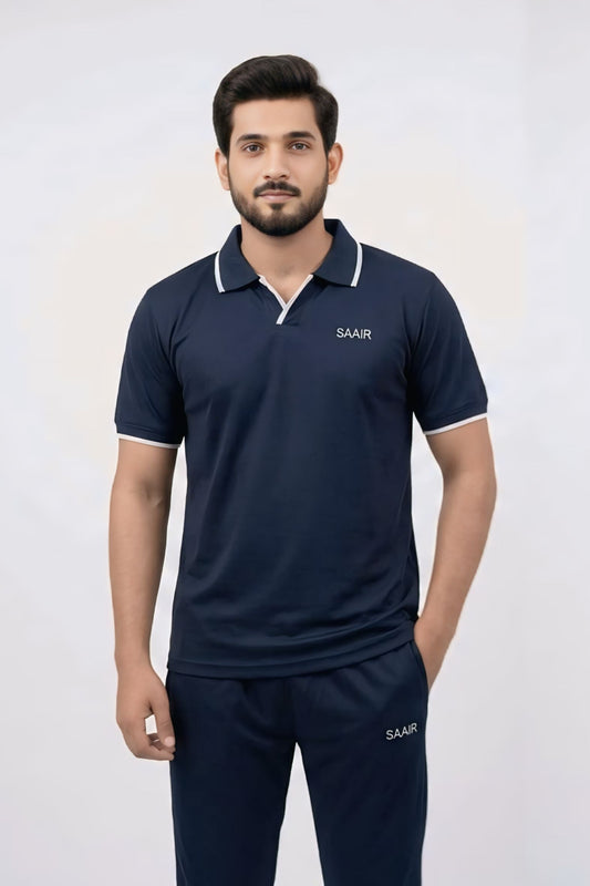 Two male models wearing matching navy blue athletic tracksuits with white trim on the collar and sleeve cuffs, featuring a polo shirt and matching pants with the brand name 'SAIR' printed on the chest and thigh.