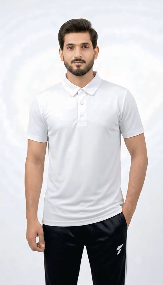 A man wearing a white short-sleeve polo shirt and black pants, standing against a light gray studio background.